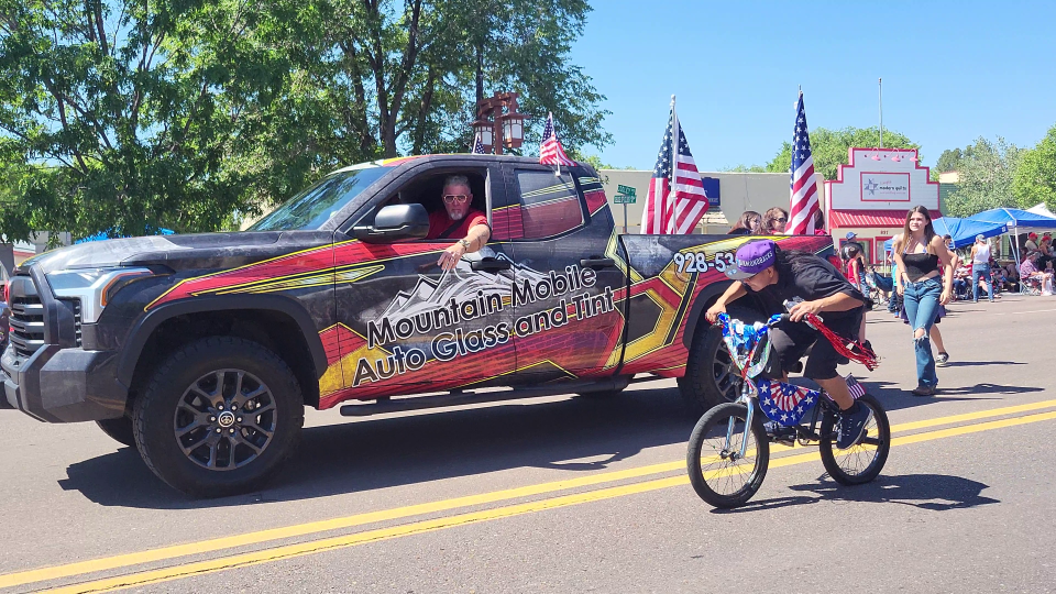 Kevin Kerr riding in his Mountain Mobile Auto Glass Truck in the 4th of July Parade